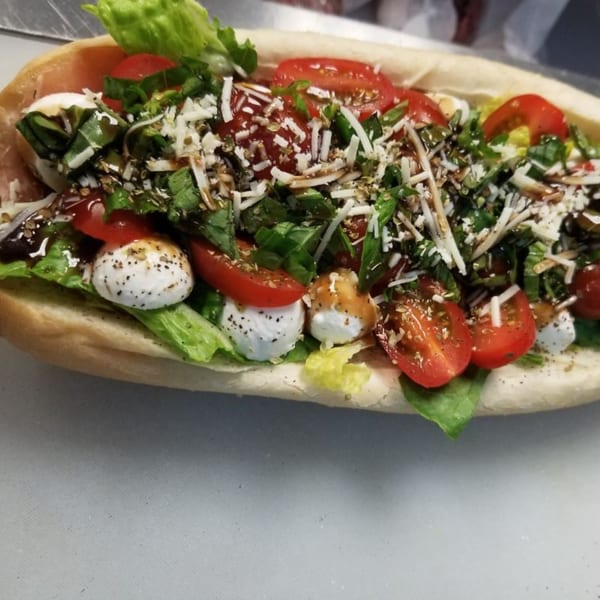 A amore pizza sub with fresh mozzarella, tomatoes, basil, and balsamic glaze.