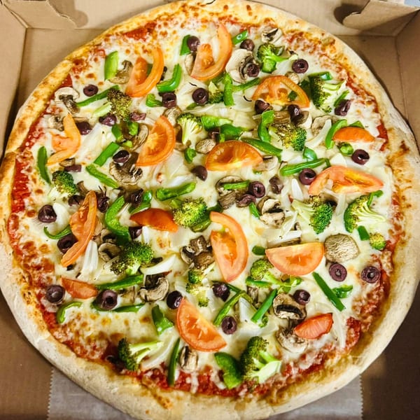 Amore Pizza's vegetarian pizza with tomatoes, broccoli, mushrooms, olives, onions, and peppers.